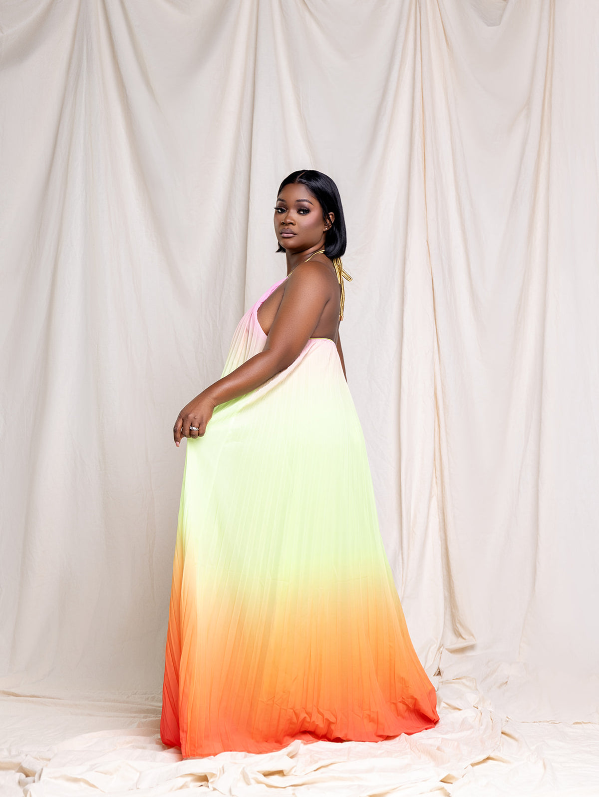 Radiant Sunset pleated maxi dress, back view showing the elastic back and flowy pleated skirt