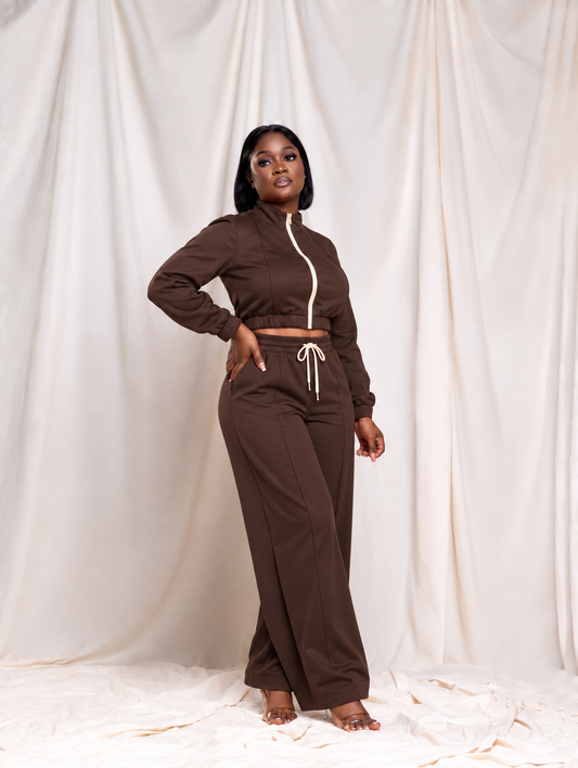 Model wearing The Elevated Zip Set in chocolate brown, cropped stand-collar zip jacket with cream zipper and wide-leg drawstring pants, front view
